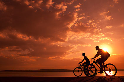 Bike riders enjoy the sunset near Seascape at Weymouth on the South Shore