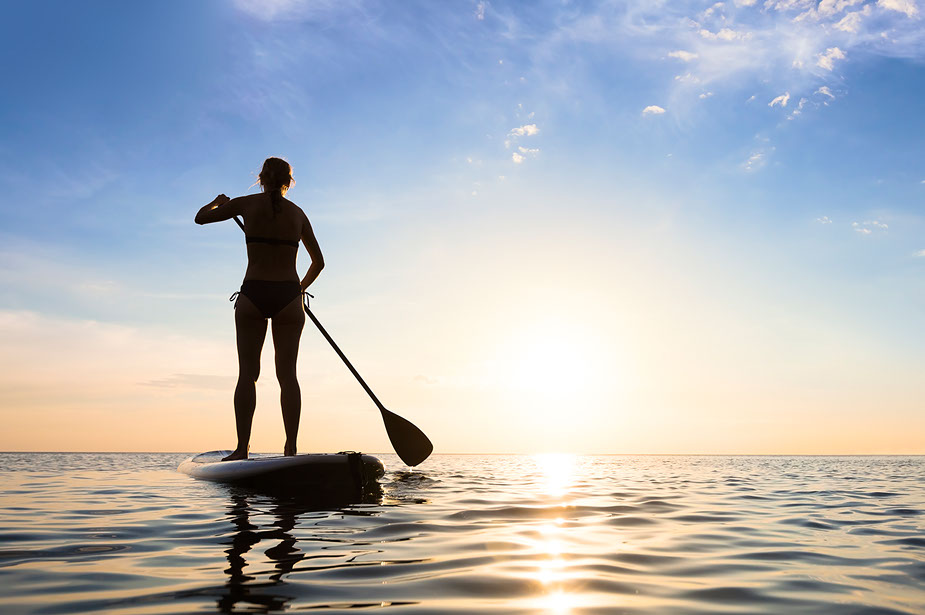 Paddleboarder enjoying ocean views of Hingham Bay, the Boston Skyline, Back River, and Hingham Shipyard on the South Shore