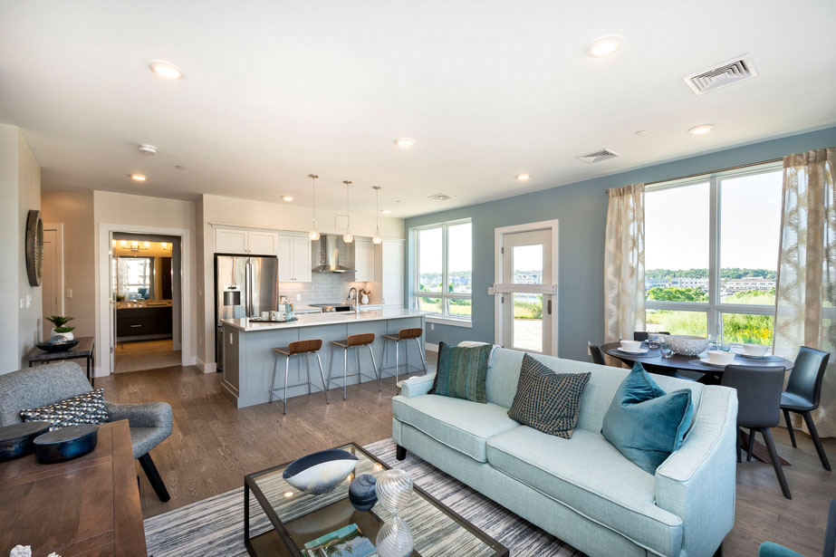 Couple with coffee mugs enjoying scenic views out the large windows at Seascape at Weymouth