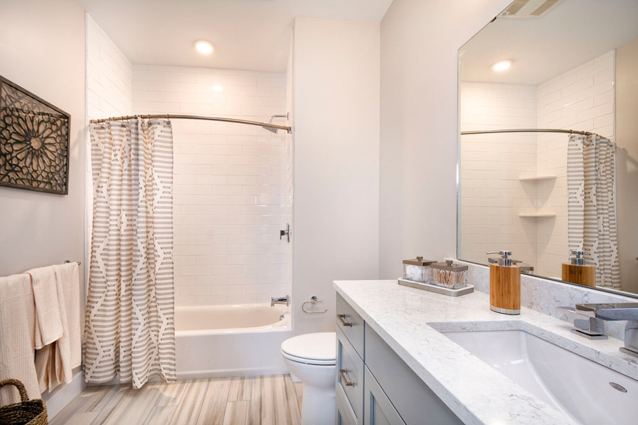Couple with coffee mugs enjoying scenic views out the large windows at Seascape at Weymouth
