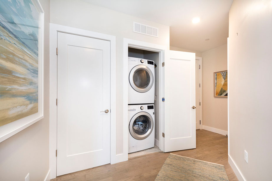Couple with coffee mugs enjoying scenic views out the large windows at Seascape at Weymouth