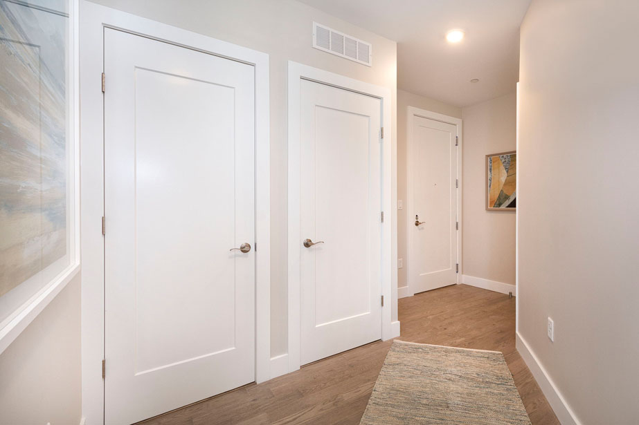 Couple with coffee mugs enjoying scenic views out the large windows at Seascape at Weymouth