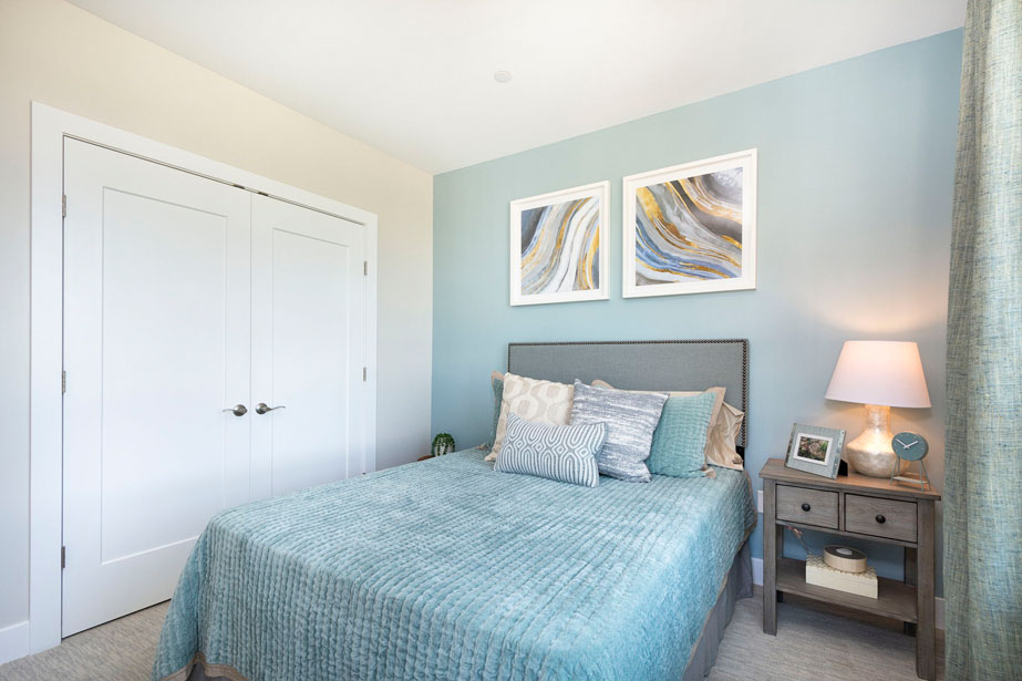 Couple with coffee mugs enjoying scenic views out the large windows at Seascape at Weymouth