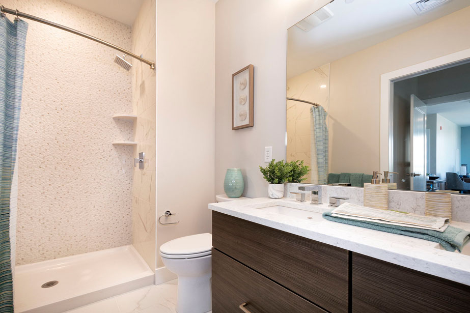 Couple with coffee mugs enjoying scenic views out the large windows at Seascape at Weymouth