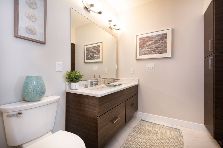 Couple with coffee mugs enjoying scenic views out the large windows at Seascape at Weymouth