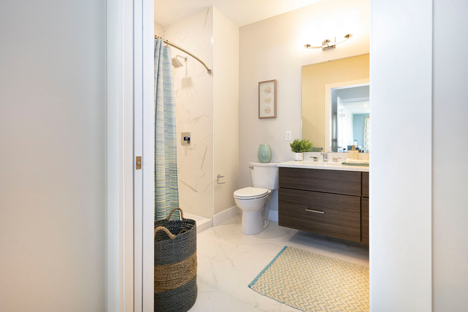 Couple with coffee mugs enjoying scenic views out the large windows at Seascape at Weymouth