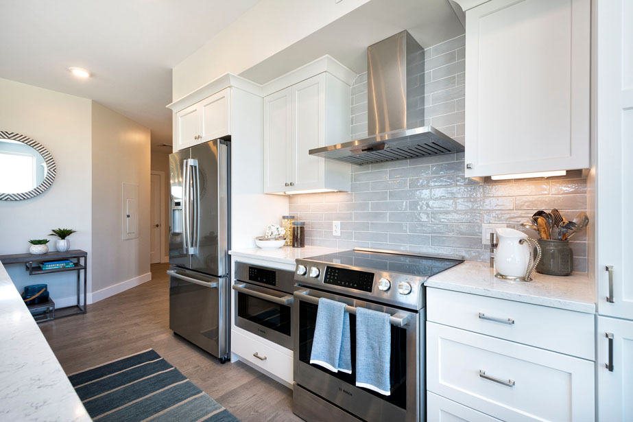 Couple with coffee mugs enjoying scenic views out the large windows at Seascape at Weymouth