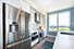 Couple with coffee mugs enjoying scenic views out the large windows at Seascape at Weymouth