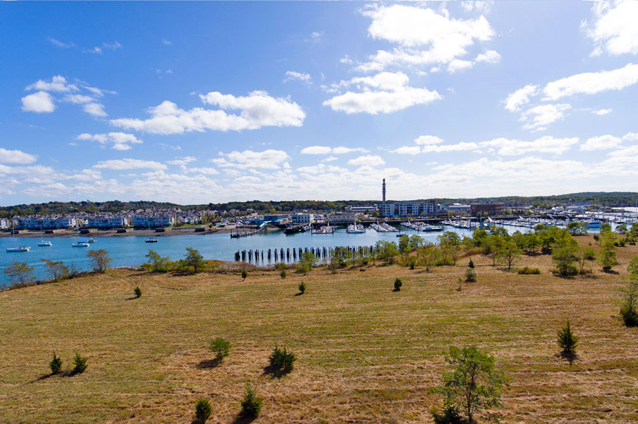 Couple with coffee mugs enjoying scenic views out the large windows at Seascape at Weymouth