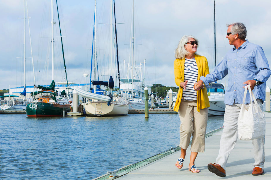 Mature couple walking at Hingham Shipyard Marina near Seascape at Weymouth