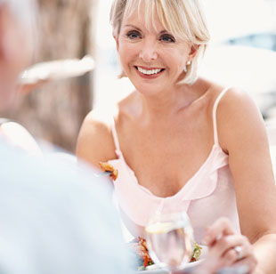 Mature lady having dinner near Seascape at Weymouth