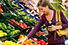Young adult female shopping for fresh produce near Seascape at Weymouth