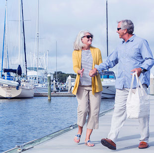 Mature couple walking at marina near Seascape at Weymouth