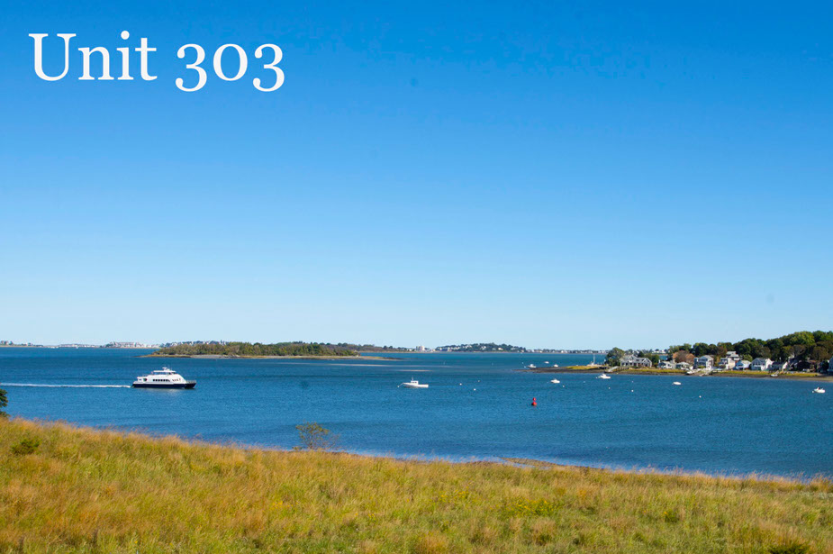 Couple with coffee mugs enjoying scenic views out the large windows at Seascape at Weymouth