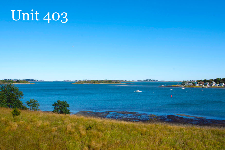 Couple with coffee mugs enjoying scenic views out the large windows at Seascape at Weymouth
