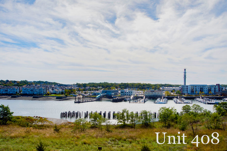 Couple with coffee mugs enjoying scenic views out the large windows at Seascape at Weymouth