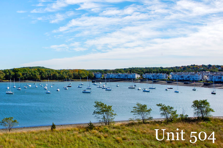 Couple with coffee mugs enjoying scenic views out the large windows at Seascape at Weymouth