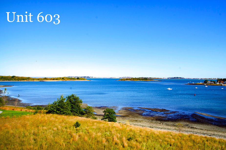 Couple with coffee mugs enjoying scenic views out the large windows at Seascape at Weymouth